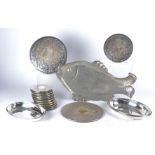 A repoussé tin tray modelled as a fish, length 48cm, together with two silver plated oval dishes and