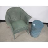 A Lloyd Loom arm chair, label to underside, sold together with a circular laundry basket