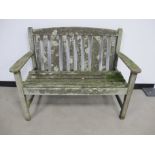 A weathered two seater teak garden bench, made by Listers , 114cm x 59cm x 86cm