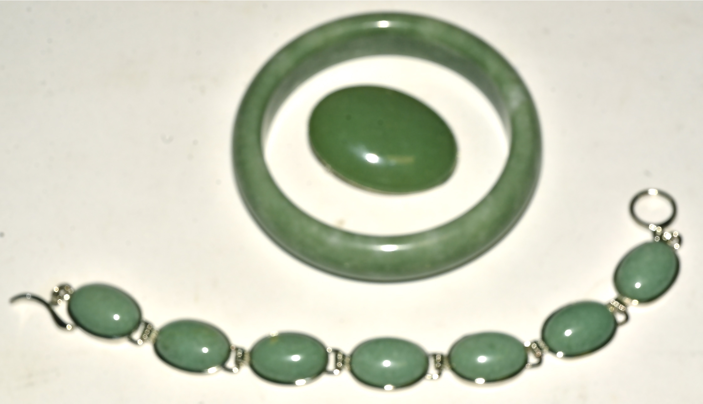 A hardstone bangle, together with a similar brooch and bracelet (3)