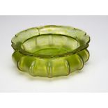 A Bohemian iridescent green glass shallow centrepiece, of lobed circular form with inverted neck and