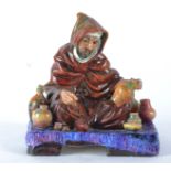 A Royal Doulton Figure of 'The Potter' HN1519, seated cross-legged surrounded by pots, height