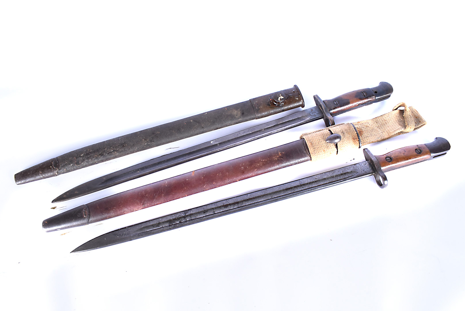 Two SMLE bayonets and scabbards, one with frog, both 1907, one marked EFD to blade, both having