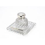 A War Department silver and glass inkwell and stand, the glass body and stand with swirl design,