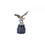 A Vintage silvered car mascot, in form of a bird of prey, unnamed, on turned wooden plinth approx