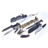 A group of four modern hunting knives, including a Buck, an MM, an Imperial, and a Rostfrei, with