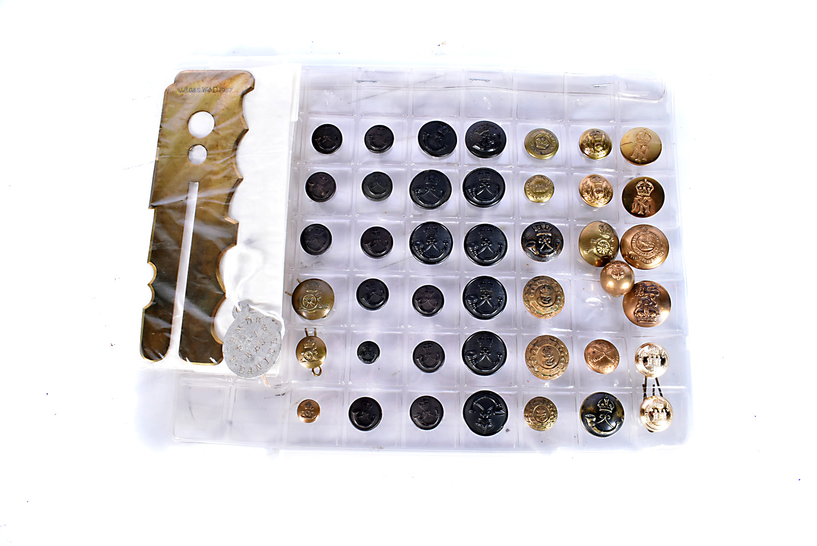 An assortment of various buttons, together with a button cleaner and a dog tag for Royal Naval