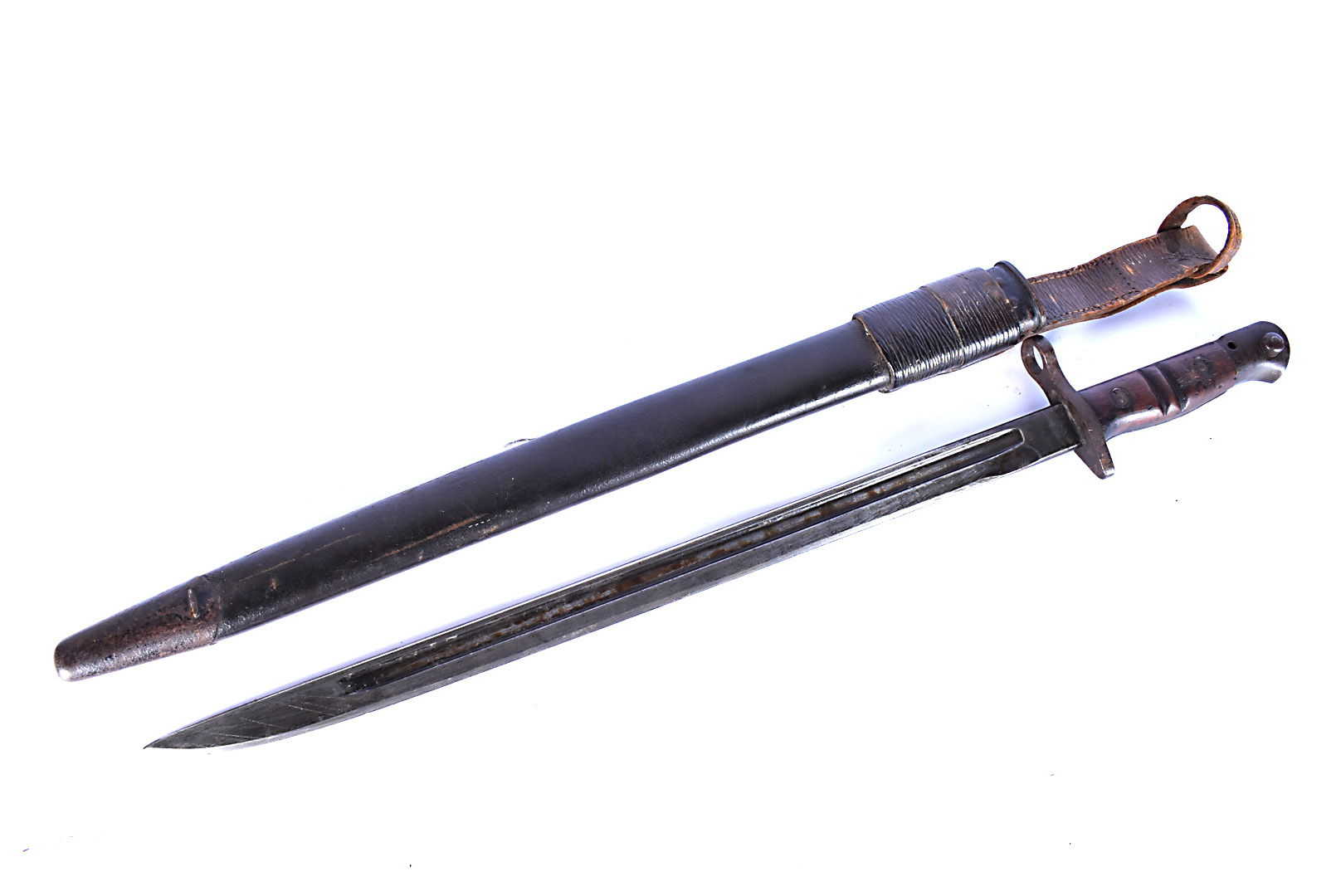 A US Remington 1917 bayonet and scabbard, marked to the single fullered blade, with leather and