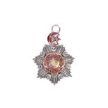 A Turkish Ottoman Order of Medjidie neck badge, the mixed metal badge with red enamel decoration,