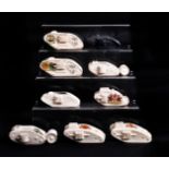 A group of nine WWI crested china models of tanks, various manufacturers and British tanks, with