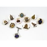 An assortment of mother of pearl sweetheart brooches, to include Merchant Navy, The Queens, The