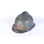 A War Period Adrian helmet, in green, possibly French, missing badge to the front, complete with