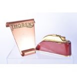 A Thorens table lighter/music box, in maroon, with damages, together with a Thorens Pocket lighter
