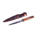 A 3rd Pattern Fairbairn Sykes Fighting dagger, having turned wooden handle, with leather sheath (2)