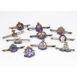 A group of eleven silver marked silver and enamel regimental sweetheart brooches, including George V