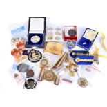 An assortment of various items, to include a Rhodesian belt buckle, cap badges, metal and cloth,