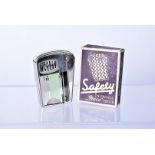 An Art Deco IMCO Safety lighter, having black, green and silver design to the side marked to