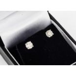 A pair of brilliant cut diamond ear studs, in 18ct white gold claw settings, total diamond weight