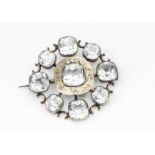 A 19th Century paste, white metal and gold sunburst brooch, with cushion cut paste stones, central