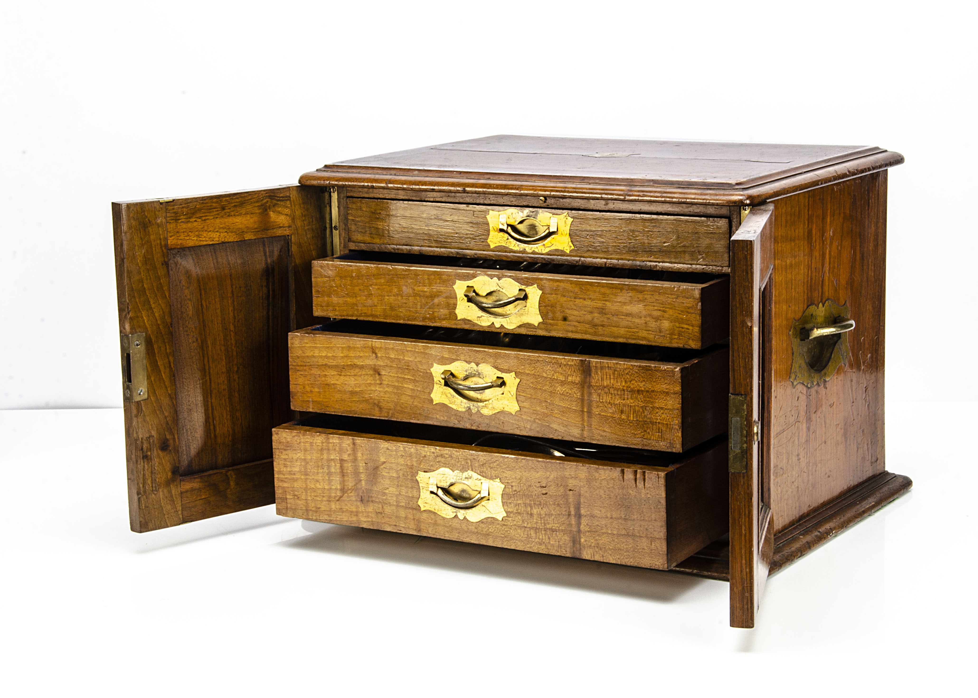 A Victorian walnut cutlery box, with a pair of hinged front doors opening to reveal four graduated