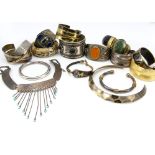 A collection of white metal and base metal bangles, including a horn and hardstone example, a
