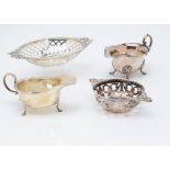 A late Victorian silver oval pierced bon bon dish, together with a George V silver sauce boat and