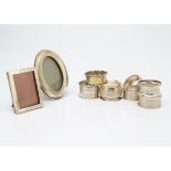 Seven various silver napkin rings, together with two small silver mounted photograph frames (9)