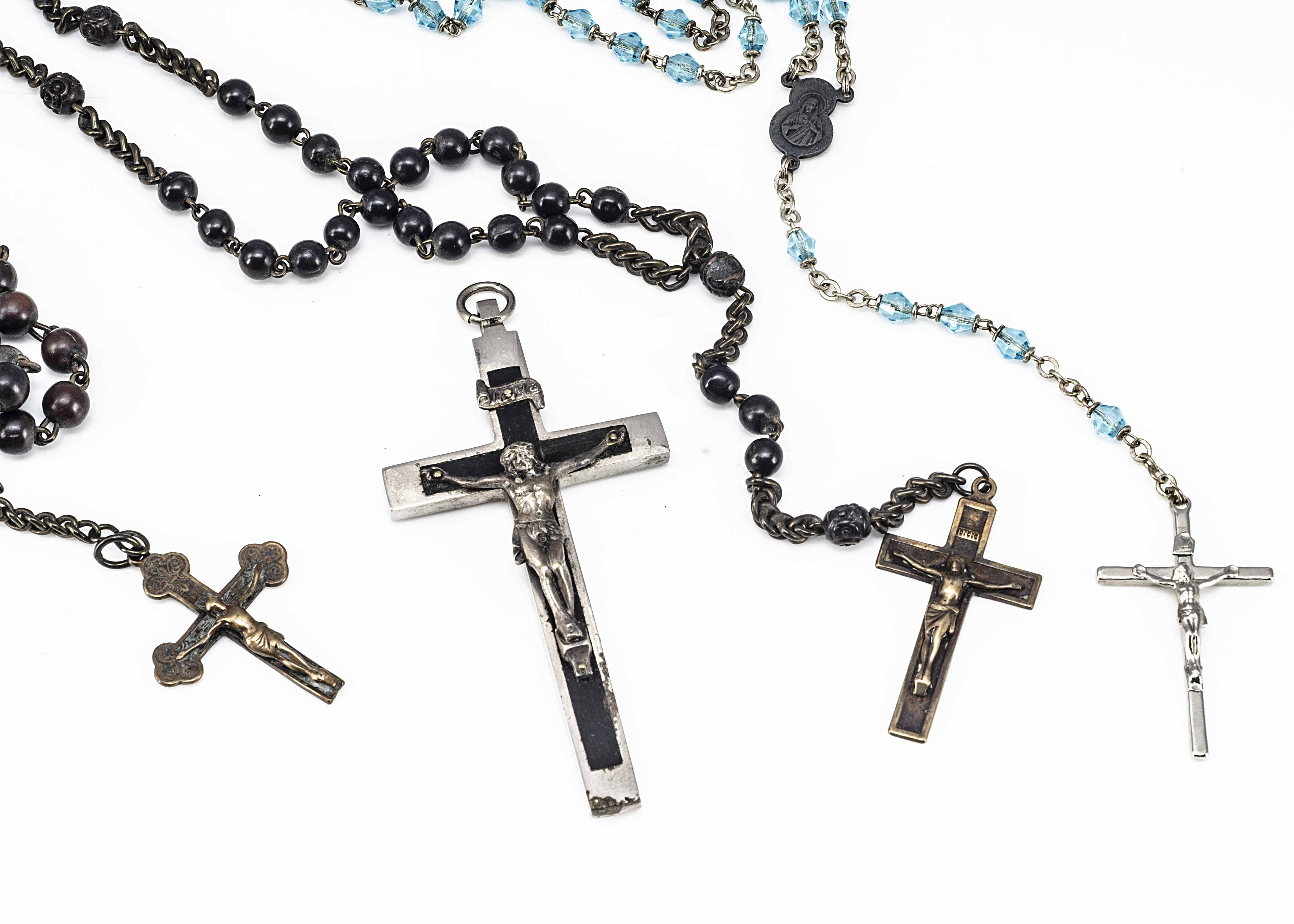 Two early 20th Century ebony and brass rosaries, together with a silver plated and ebony crucifix