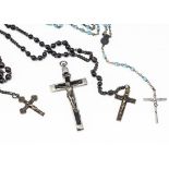 Two early 20th Century ebony and brass rosaries, together with a silver plated and ebony crucifix