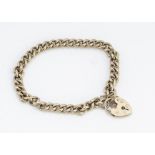 A 9ct gold curb linked and padlock clasp bracelet, with safety chain, 21cm, 23g