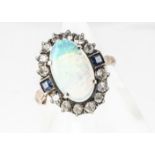 An opal and paste set dress ring, in white and gilt metal, the cluster mount with central oval