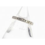 A modern diamond half hoop eternity ring, the princess cut in channel setting all in white 18ct