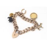 A 9ct gold charm bracelet, the hollow curb links with various charms including an Edward VII half