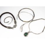 A collection of silver and white metal torques and necklaces, including a plaited leather and