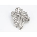 An Art Deco diamond and platinum double clip bow brooch, set mostly with eight cut diamonds and