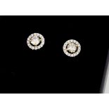 A pair of contemporary diamond ear studs, brilliant cuts in halo bezels, diamonds 0.66ct