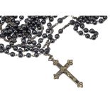 An early 20th Century ebony, brass and base metal extra long rosary, with engraved mother and