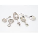 Three late 19th and early 20th Century continental white metal spoons, two tea caddy spoons,