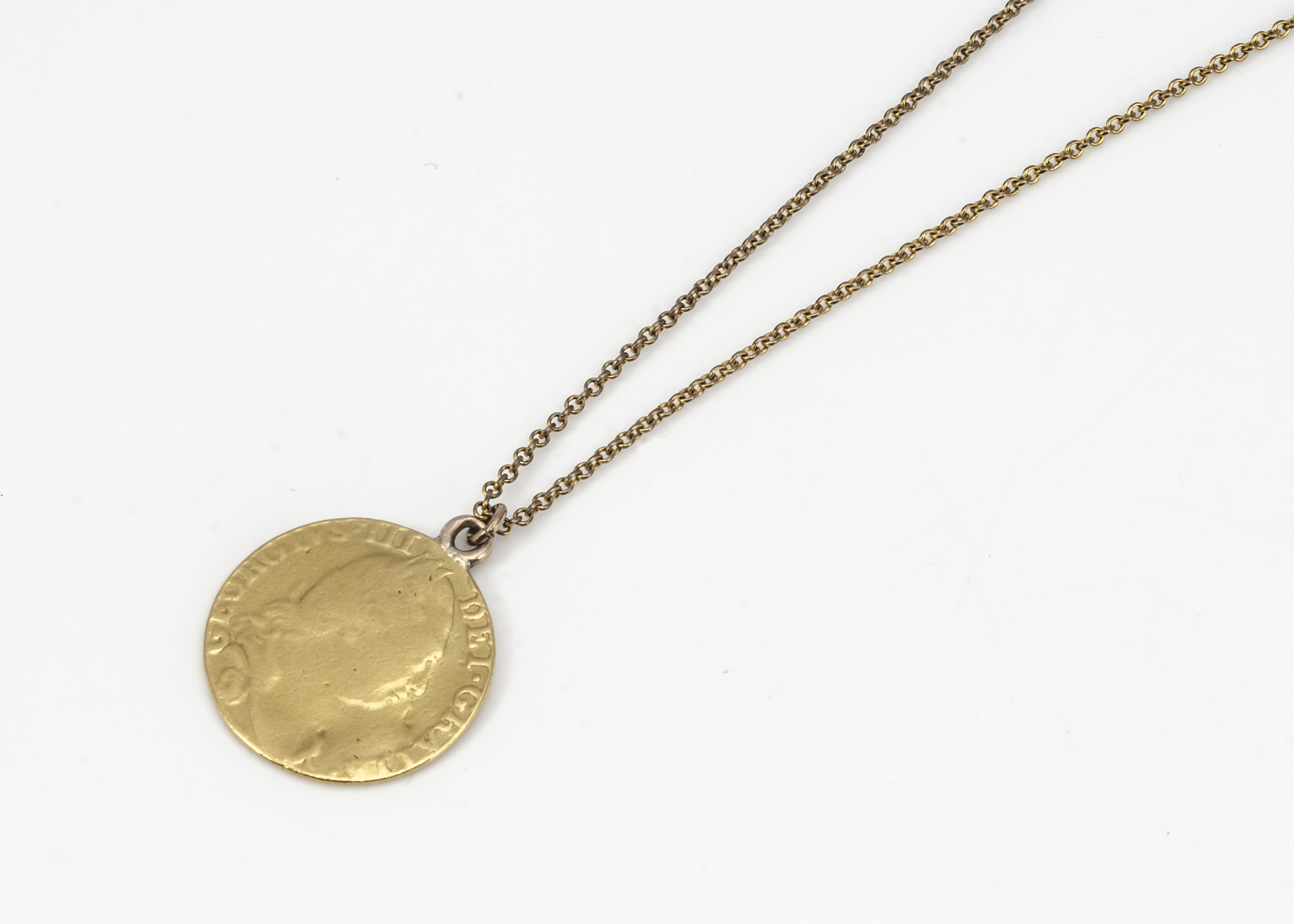 A George III 1784 spade guinea pendant, on a gilt metal chain, pendant 8.5g, 2.4cm diameter - Image 2 of 2