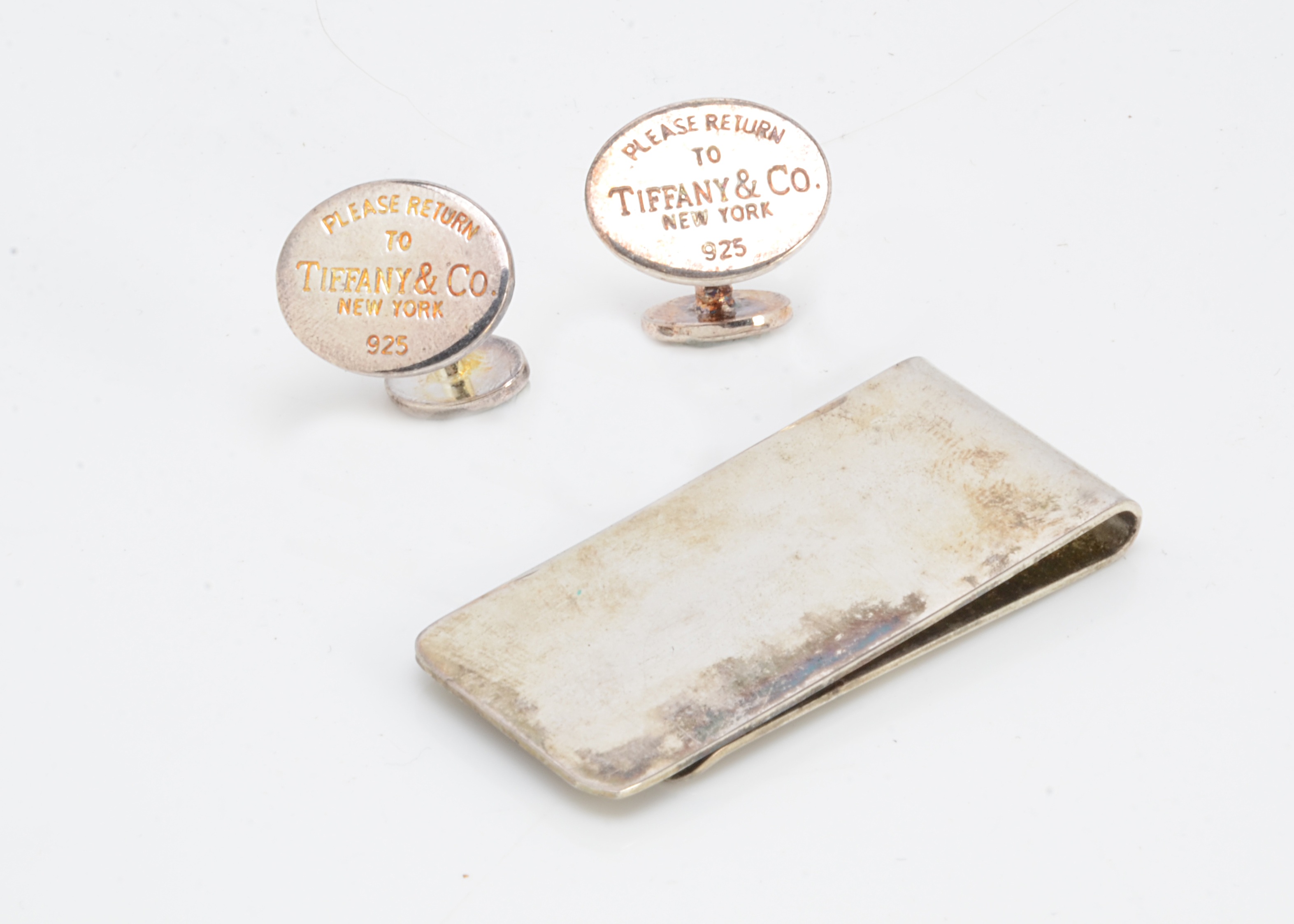 A pair of white metal cufflinks, marked Tiffany & Co, together with a silver plated money clip (3)