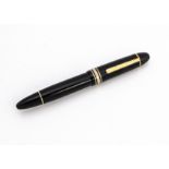 A Mont Blanc fountain pen, the Meisterstuck No. 149 in black with gold additions, crack to top of