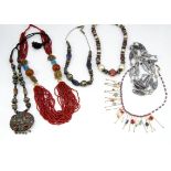 A collection of North African and Middle Eastern bead jewellery, set with cornelian, lapis lazuli,