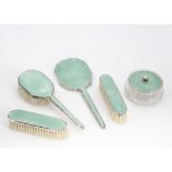 An Art Deco period silver and enamelled dressing table set by Adie Bros, comprising powder puff pot,