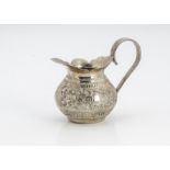 A small Middle Eastern white metal jug, probably c1900 from Burma, dented, 2.9 ozt, 8.5cm high