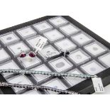 A collection of loose cut gemstones in presentation perspex cases, together with a quantity of