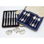 A cased set of six George V silver teaspoons with sugar tongs, together with a cased set of six