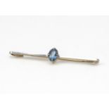 A 15ct gold and platinum aquamarine bar brooch, the oval mixed cut in four claw setting with a white