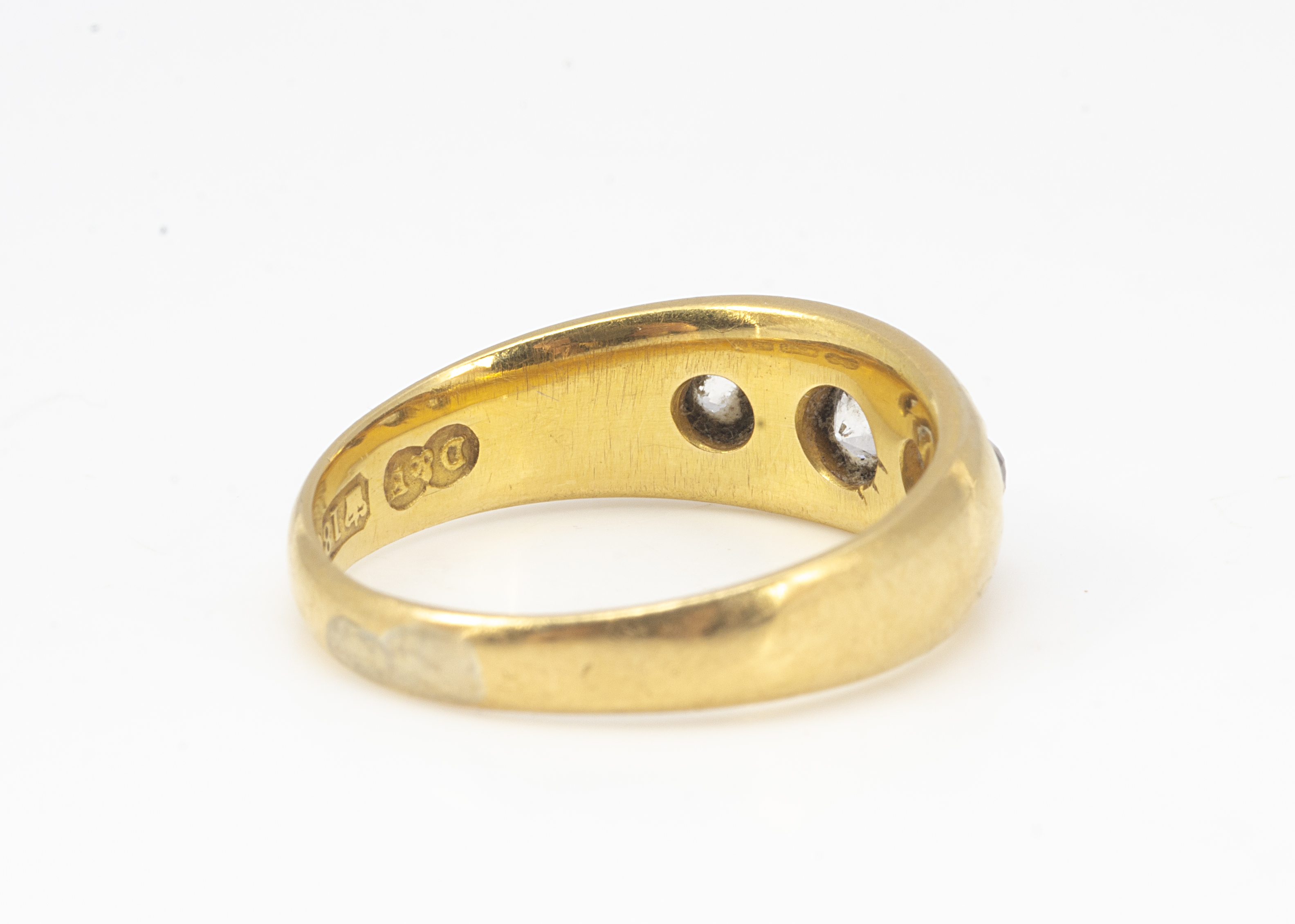 A Victorian 18ct gold three stone diamond ring, the three old cuts in gypsy setting dated Birmingham - Image 2 of 2