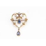 A contemporary 18ct gold heart shaped sapphire and diamond brooch, the brilliant cut diamonds within