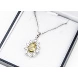A certificated fancy diamond and brilliant cut diamond set platinum pendant, of oval form, centred